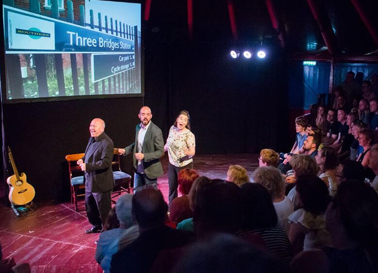 on stage at the Bosco Spiegeltent with 'Southern Fail'. Erin is singing on stage with two other performers to a full audience.